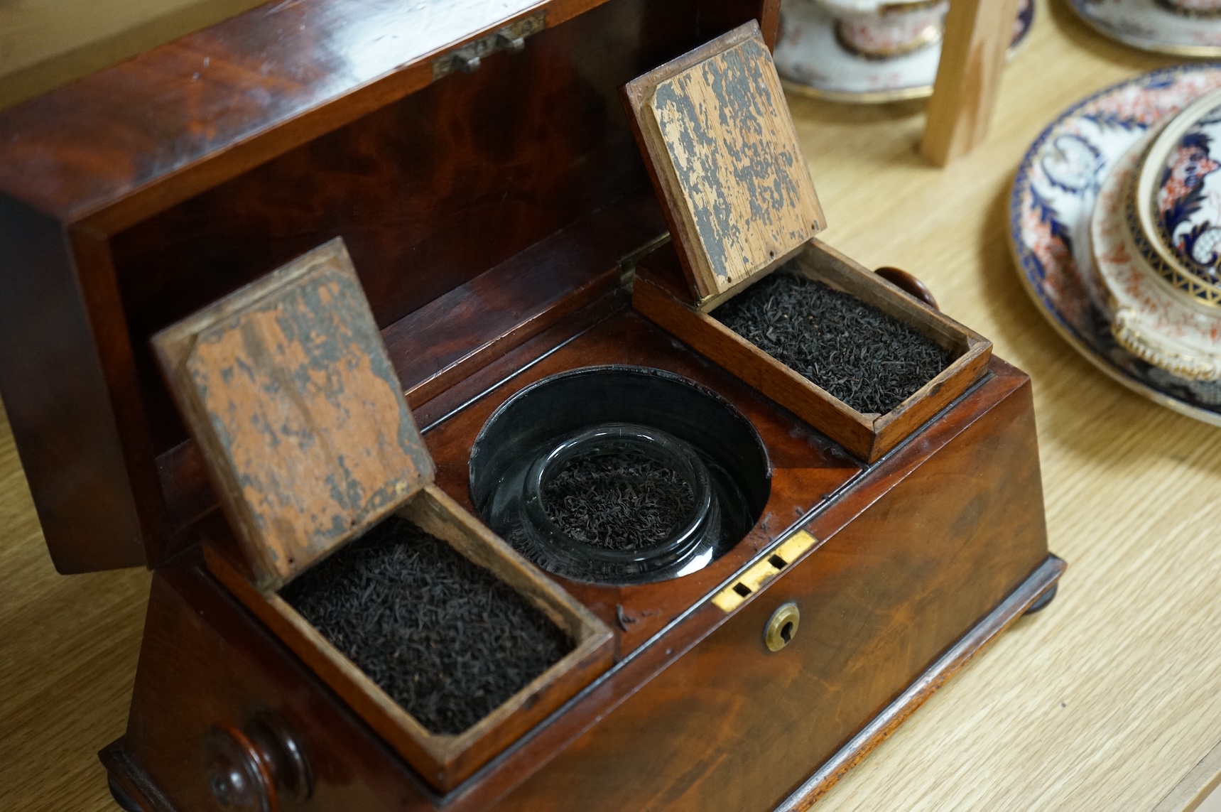 An early Victorian mahogany sarcophagus shaped tea caddy, 35cm wide